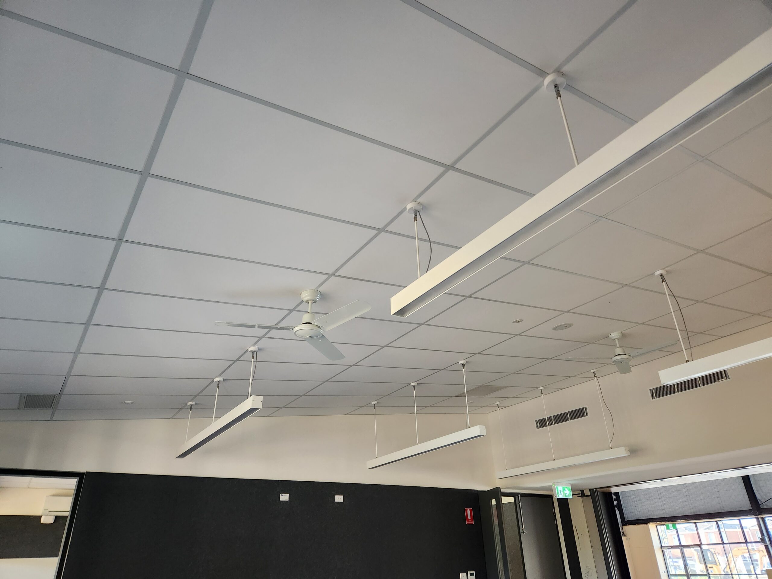 Modern ceiling with lights and fans.
